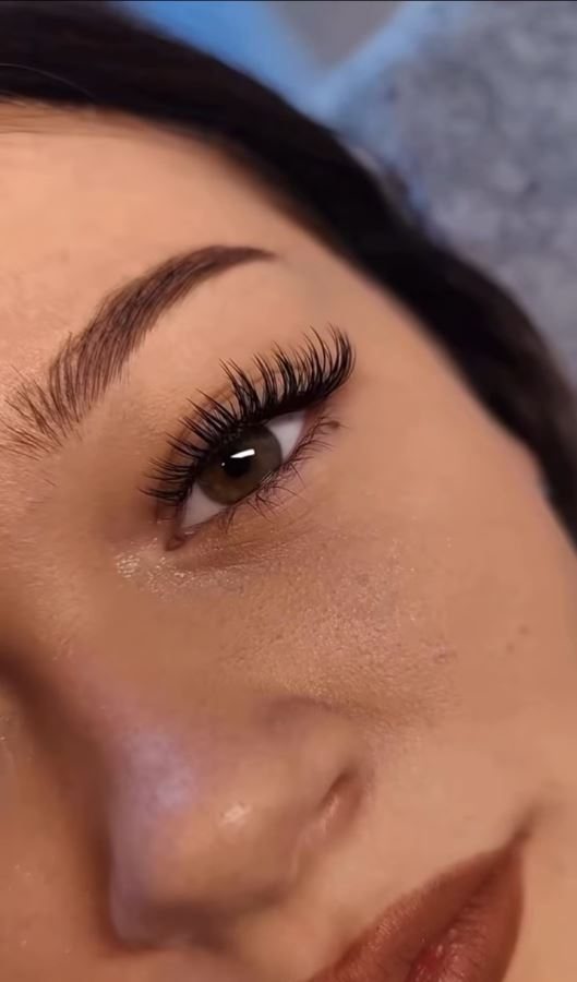 Close-up of finished lash extensions and a shaped brow