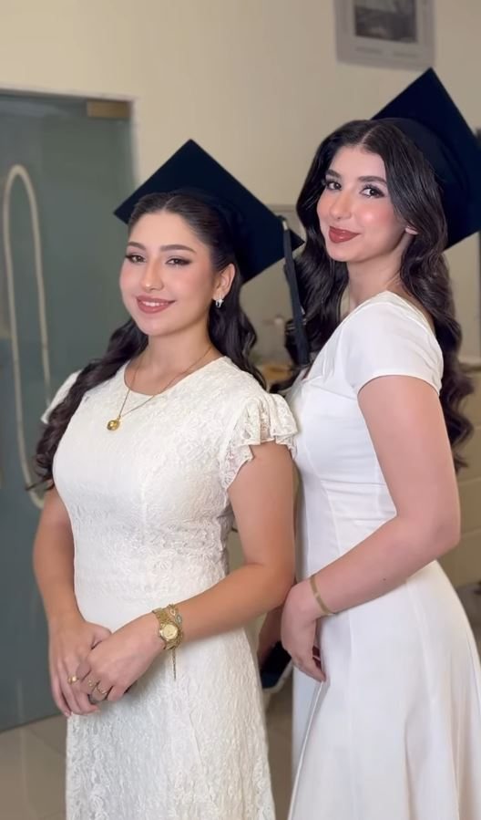 Two clients on graduation day, hair and makeup done
